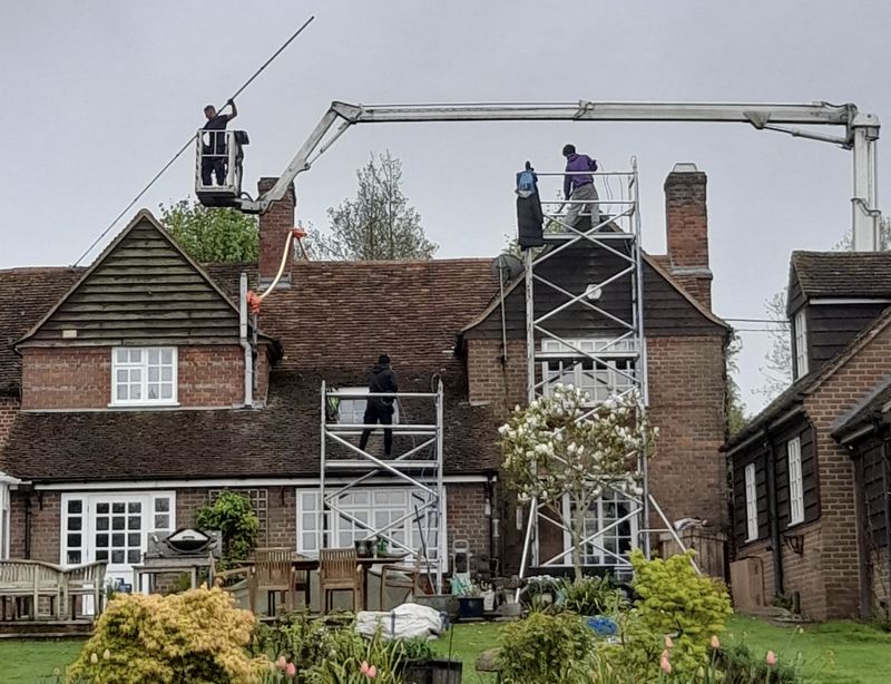 The Moss Cleaners using cherry picker and scaffolding to clean roof safely and professionally in Coleford, Gloucestershire